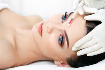 Obraz na płótnie Canvas Beautiful woman gets injections. Cosmetology. Beauty Face