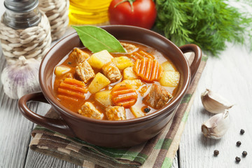 Meat with potatoes and carrots in the bowl