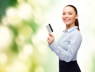 smiling businesswoman showing credit card