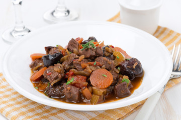 plate of stew with beef and vegetables, close-up