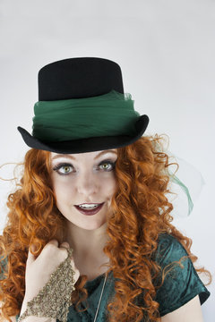 Close-up of pretty young woman wearing tophat with green tulle