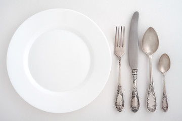 Vintage cutlery set with fork, knife, spoon and plate