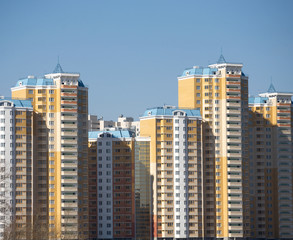 Fototapeta na wymiar New buildings over blue clear cloudless sky