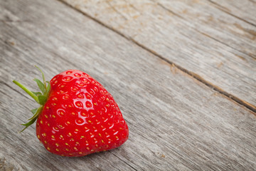 Ripe strawberry over wooden table background