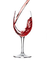 red wine pouring into wine glass isolated