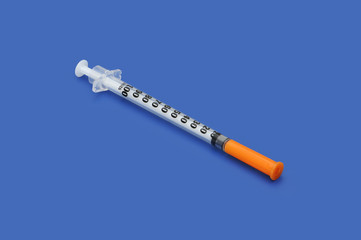 Plastic disposable syringe with a needle in the protective cap
