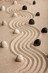 Fototapeta na wymiar line made of stones standing on the sand