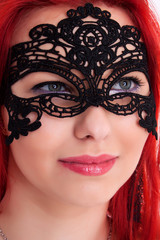 Fototapeta premium Young plump red-haired woman with mask