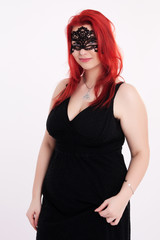 Young plump red-haired woman with mask