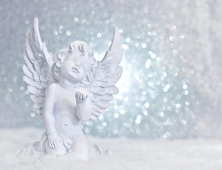 little white guardian angel in snow