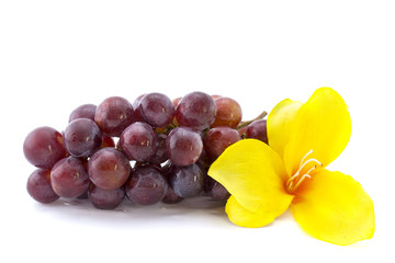 red grape isolated on white background with a yellow flower