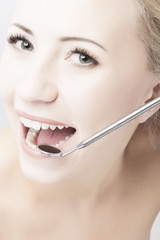 Caucasian Woman Teeth and Dental Mouth Mirror