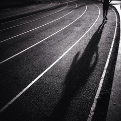 silhouette man running on track
