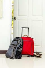 red travel bag , backpack and shoes