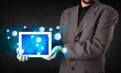 Young person holding talbet with communication technology concep