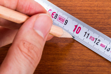 Hand Holding Pencil and Ruler