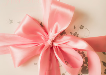 pink satin gift bow. Ribbon. Isolated on white
