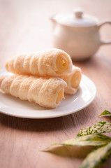 Cream-filled pastry roll on the wood board, relaxing tea time