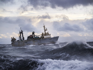 Fishing ship in strong storm.