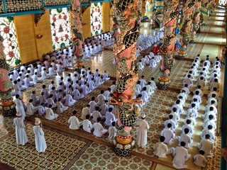Meditating followers in worship service, Cao Dai Temple, Vietnam
