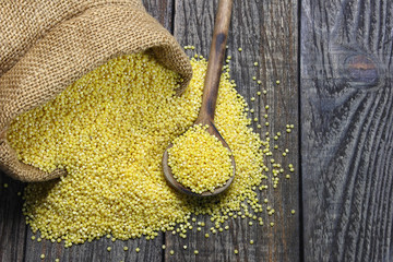Raw millet on a wooden table