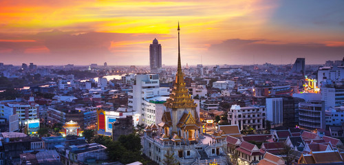 Urban City Skyline with Wat Traimit (Temple) Bangkok, Thailand.