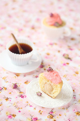 Lychee Rose Cupcake on a pink floral background.