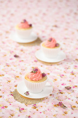 Lychee Rose Cupcakes on a pink floral background.