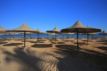 Straw umbrellas on the beach in the resort of Sharm El Sheikh