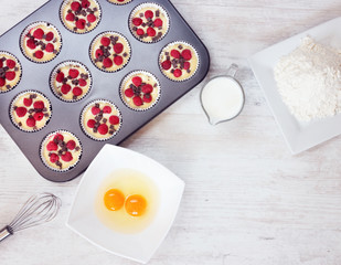 Top view of unripe muffins with ingredients