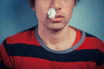 Man with nose bleed and cold sores - 64249346