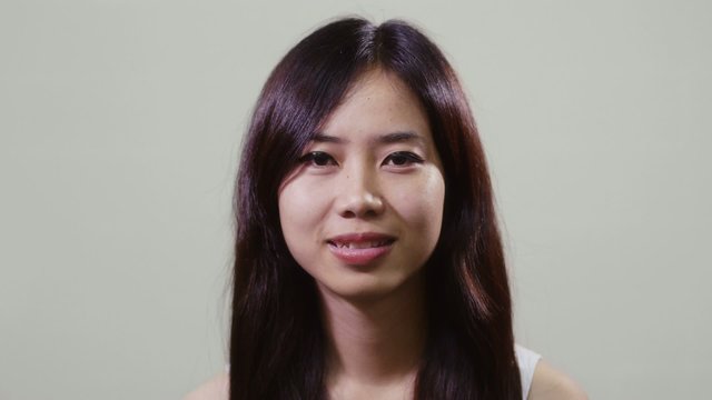 Portrait of asian woman looking at camera, young people