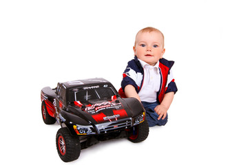 Fototapeta premium little boy plays with toy car