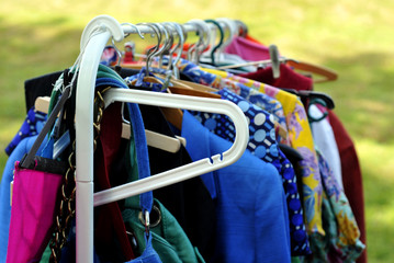 clothes on a rack in a flea market - 64252326