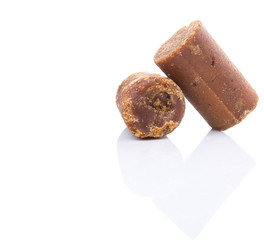 Brown coconut sugar over white background