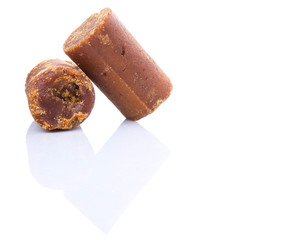 Brown coconut sugar over white background