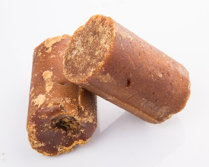 Brown coconut sugar over white background