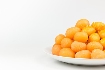 Gold egg yolks drops isolated on white background.