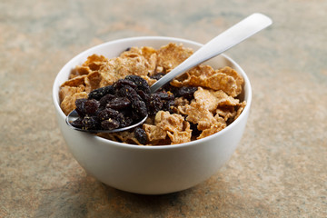 Grain Cereal and Raisins in white bowl