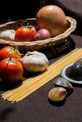 uncooked pasta and tomatoes , cartridge shells , garlic with Oni