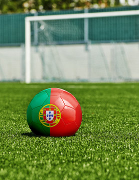 Soccer Ball with Portugal Flag on the grass in stadium