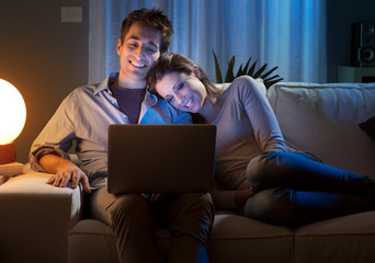 Young couple at home with laptop
