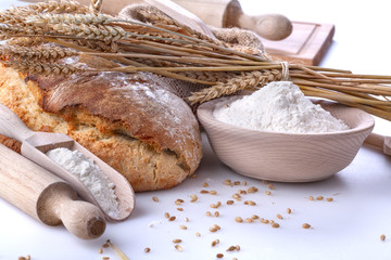 Healthy homemade bread with flour and wheat on white background