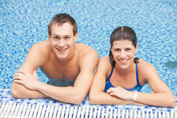 Fototapeta premium Happy positive man and woman in pool