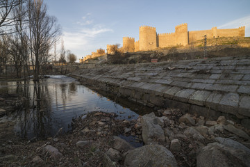 Walls of Avila (Spain) With its Reflection in the River Adaja