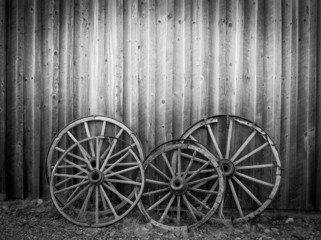 Fototapeta na wymiar Old west, old broken wood wheels with empty place for your text