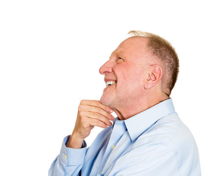 Happy daydreaming older man looking up at copy space 