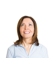 Look up. Happy middle aged woman looking up, white background 