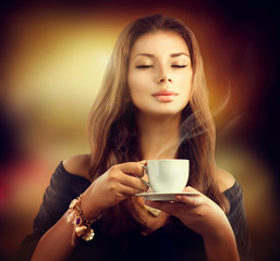 Beauty Model Girl with the Cup Tea or Coffee