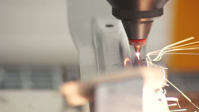 metal laser cutting detail using the robotic arm